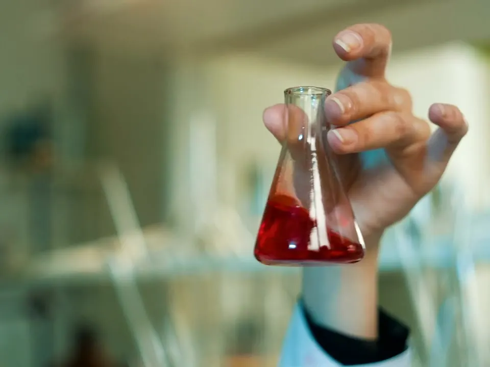 A laboratory flask with a serum-coloured liquid